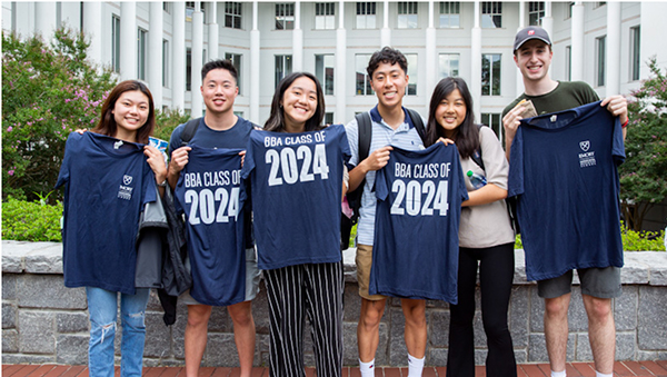 Students hold BBA 2024 t-shirts