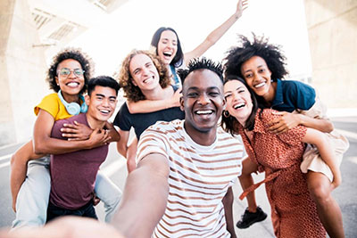 A group of students laughing and posing for the camera