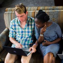 Emory students looking at a laptop