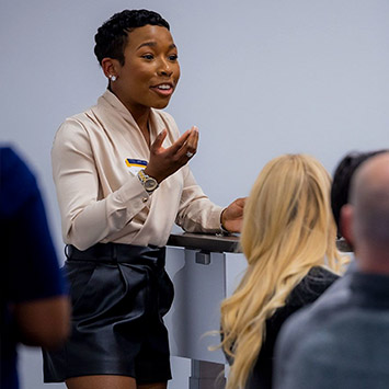 Emory professor and student talking at a table